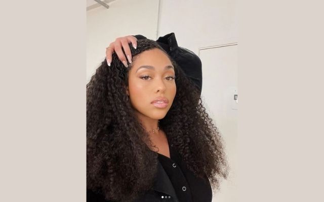 Jordyn Woods holding her hair