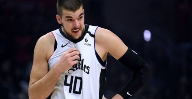 Ivica Zubac holding his uniform